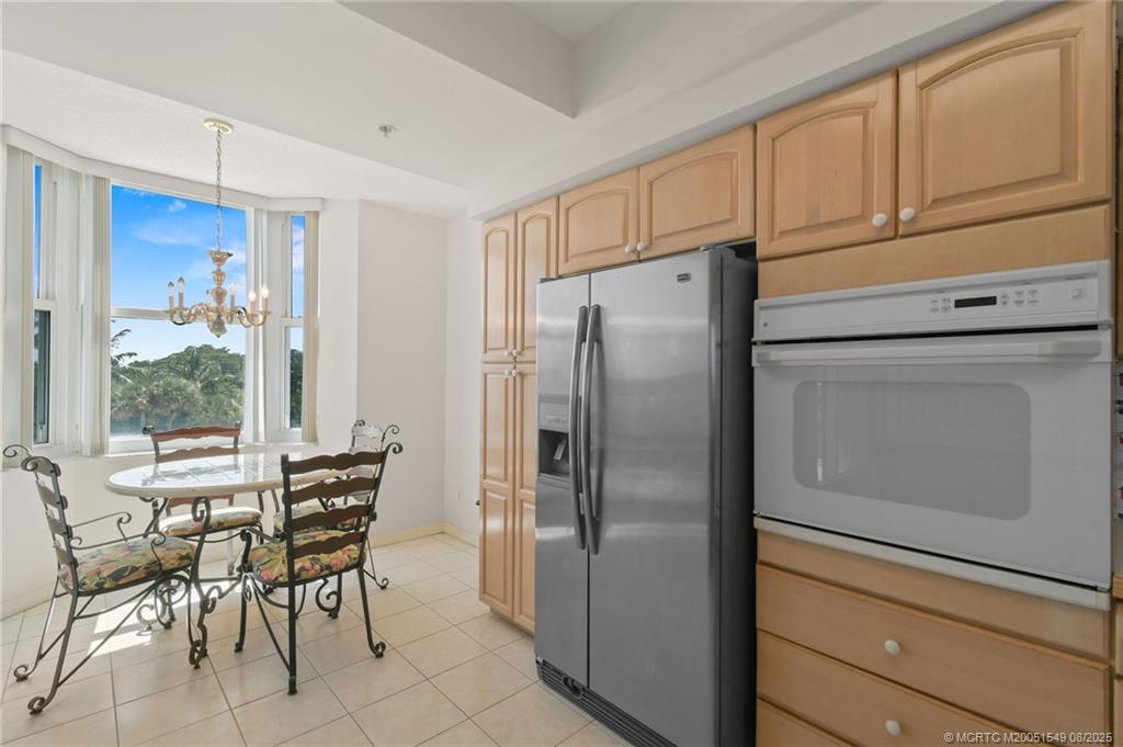 8650 South Ocean Drive, Unit 306 Jensen Beach, FL 34957 - Photo 14 of 51 a kitchen with stainless steel appliances a refrigerator stove and table