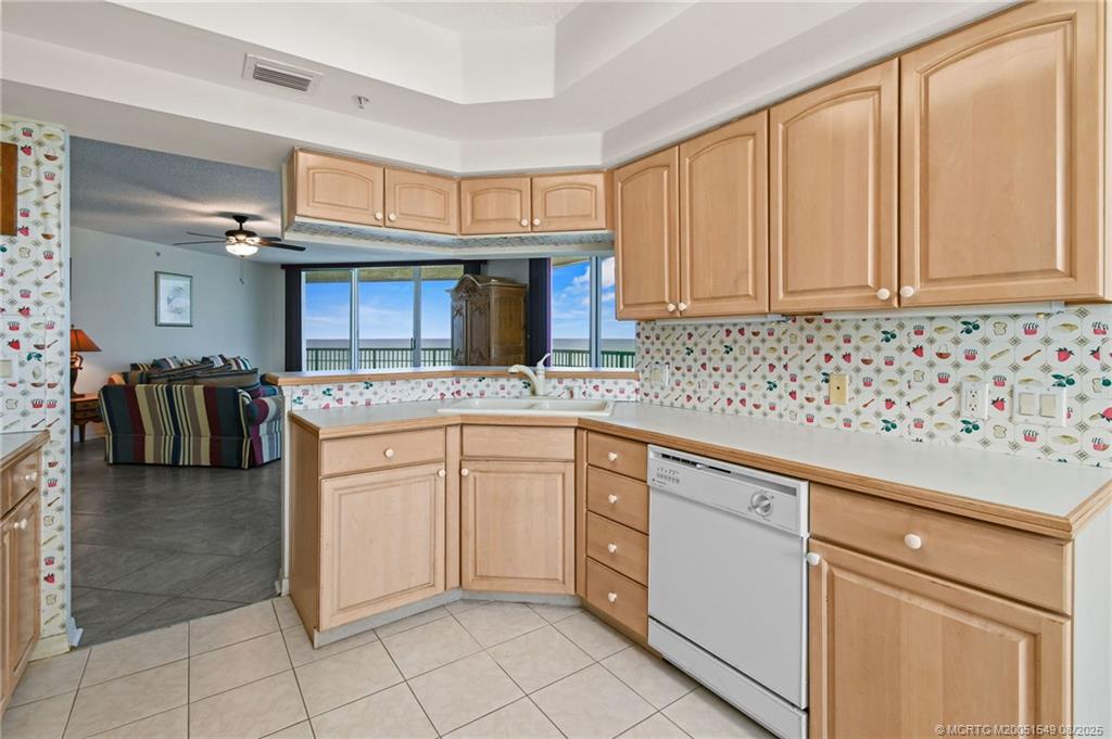 8650 South Ocean Drive, Unit 306 Jensen Beach, FL 34957 - Photo 16 of 51 a kitchen with granite countertop a sink and cabinets