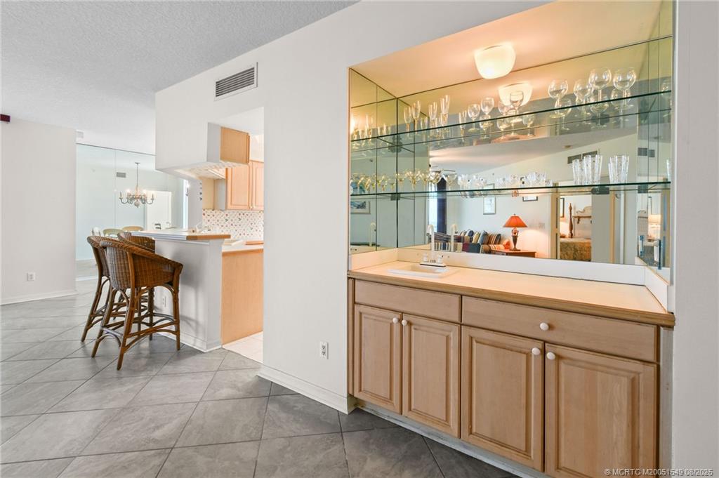 8650 South Ocean Drive, Unit 306 Jensen Beach, FL 34957 - Photo 18 of 51 a bathroom with a sink and a mirror