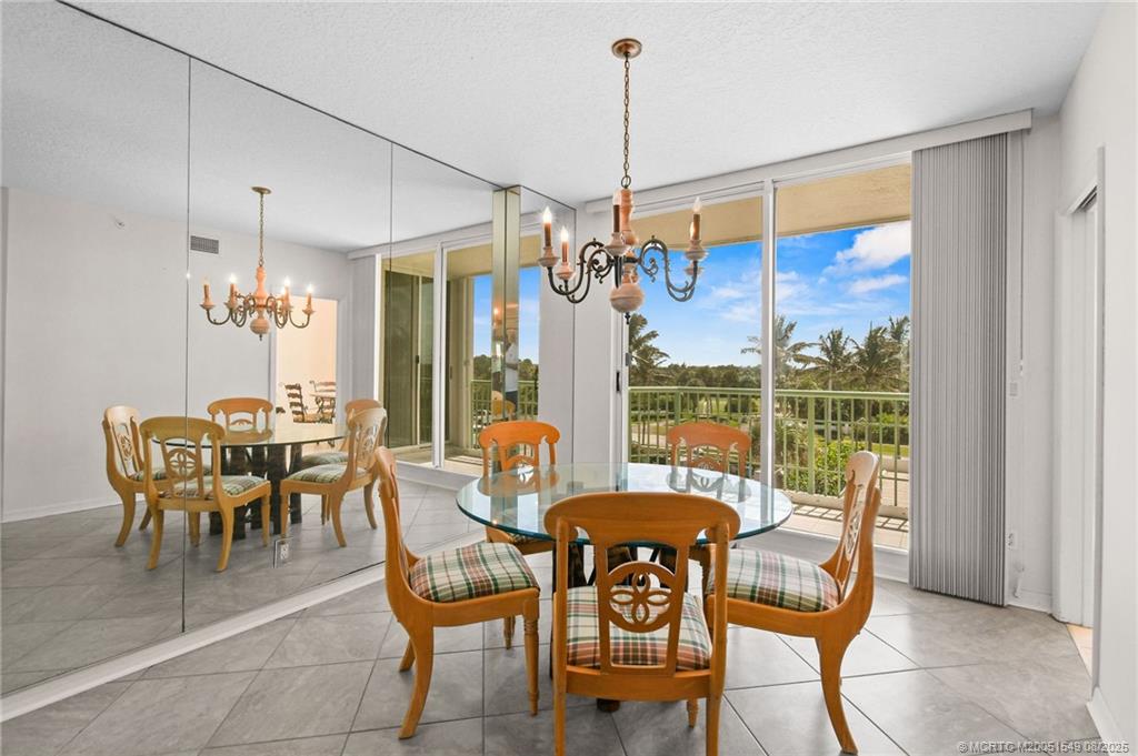 8650 South Ocean Drive, Unit 306 Jensen Beach, FL 34957 - Photo 20 of 51 a dining room with furniture a chandelier and pool table