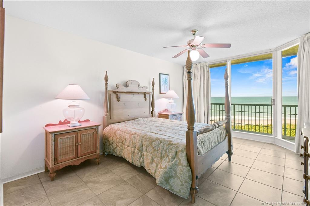 8650 South Ocean Drive, Unit 306 Jensen Beach, FL 34957 - Photo 22 of 51 a bedroom with a bed and a chandelier