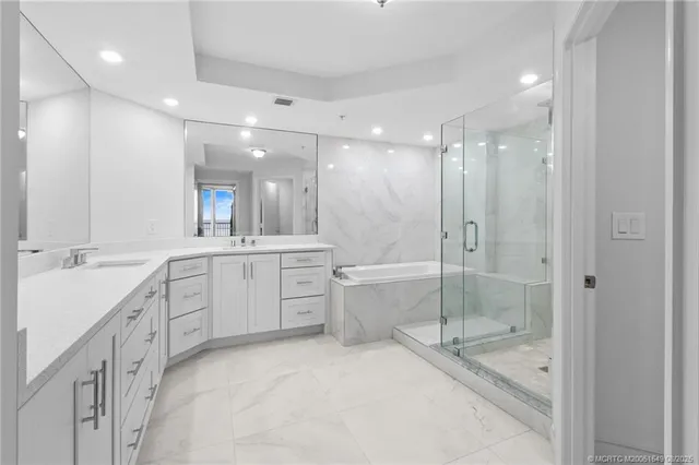 a bathroom with a bathtub sink and mirror