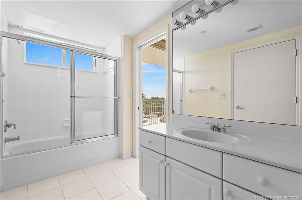 8650 South Ocean Drive, Unit 306 Jensen Beach, FL 34957 - Photo 36 of 51 a bathroom with a bathtub sink and mirror