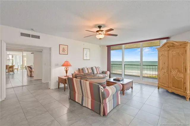 a dining room with furniture and a large window