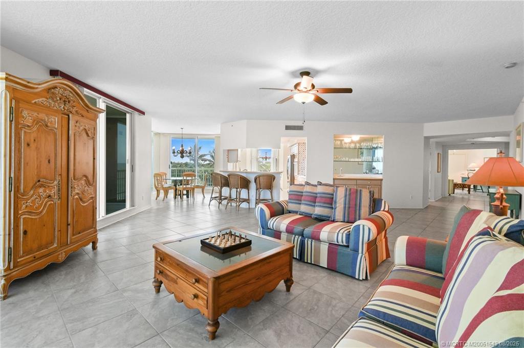 8650 South Ocean Drive, Unit 306 Jensen Beach, FL 34957 - Photo 9 of 51 a living room with furniture a ceiling fan and a window