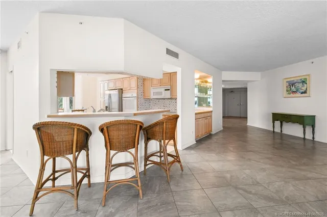 a kitchen with stainless steel appliances a refrigerator stove and table