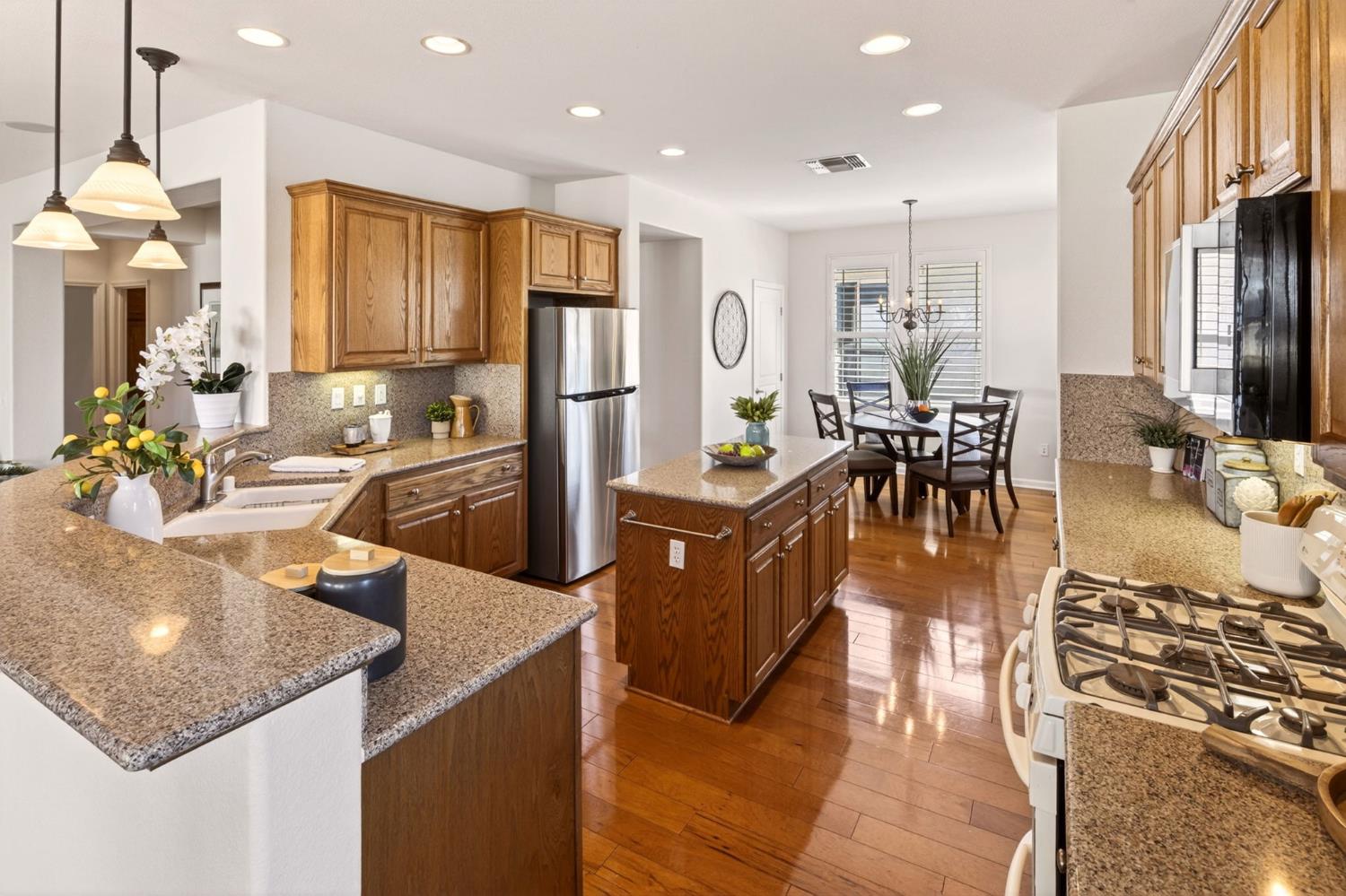 1260 Freschi Lane Lincoln, CA 95648 - Photo 20 of 60 a kitchen with counter top space a sink appliances and cabinets