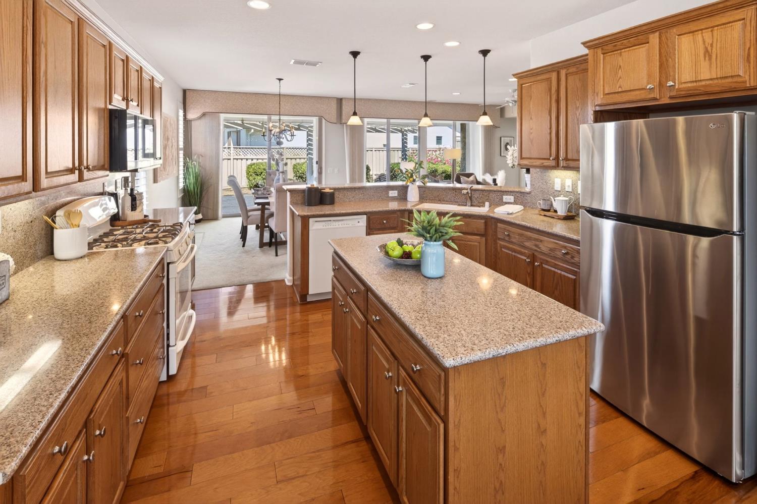 1260 Freschi Lane Lincoln, CA 95648 - Photo 22 of 60 a kitchen with stainless steel appliances granite countertop sink stove refrigerator and cabinets