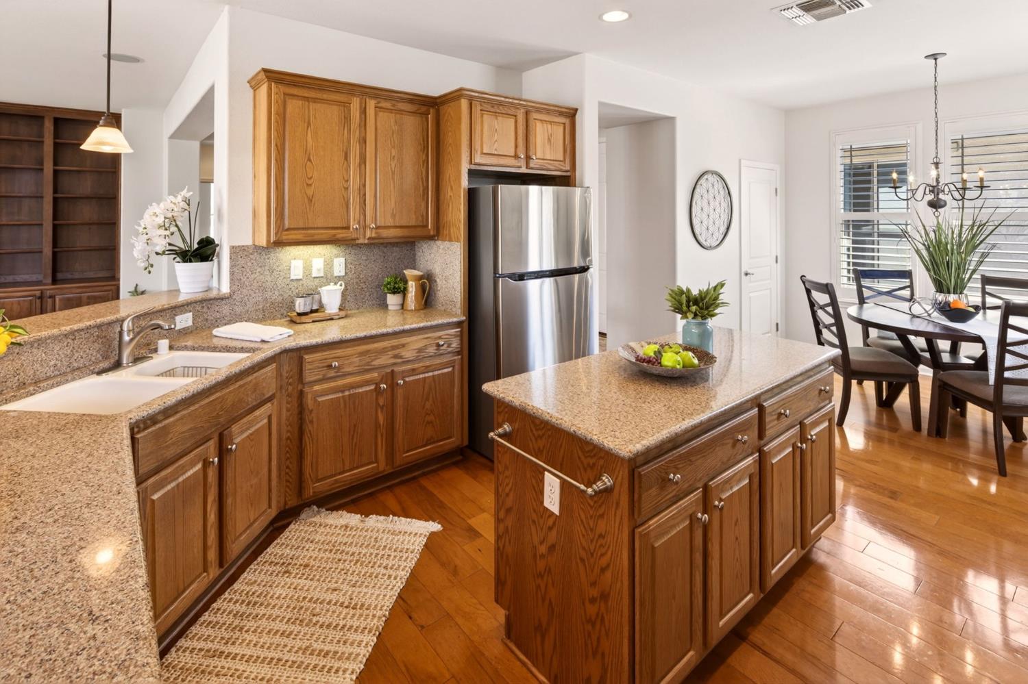 1260 Freschi Lane Lincoln, CA 95648 - Photo 23 of 60 a kitchen with granite countertop stainless steel appliances a sink counter space and a window