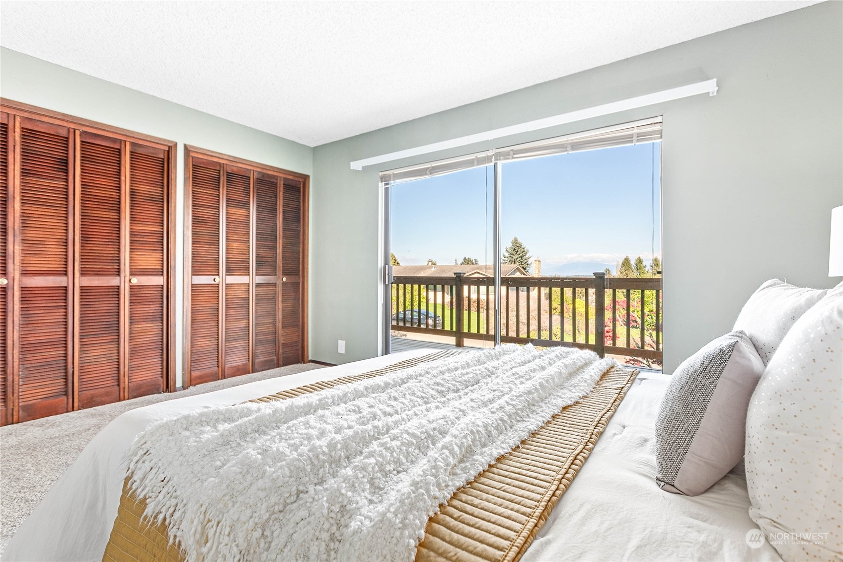 2585 Mountain View Road Ferndale, WA 98248 - Photo 23 of 40 a bed sitting in a bedroom next to a window