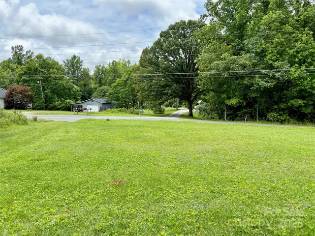 a view of a field with a trees in the background