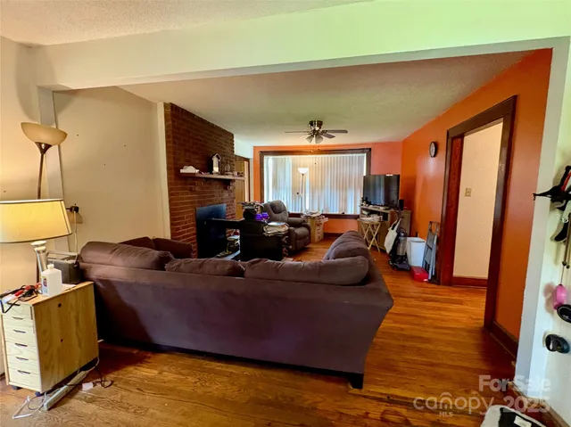 a living room with furniture and a fireplace