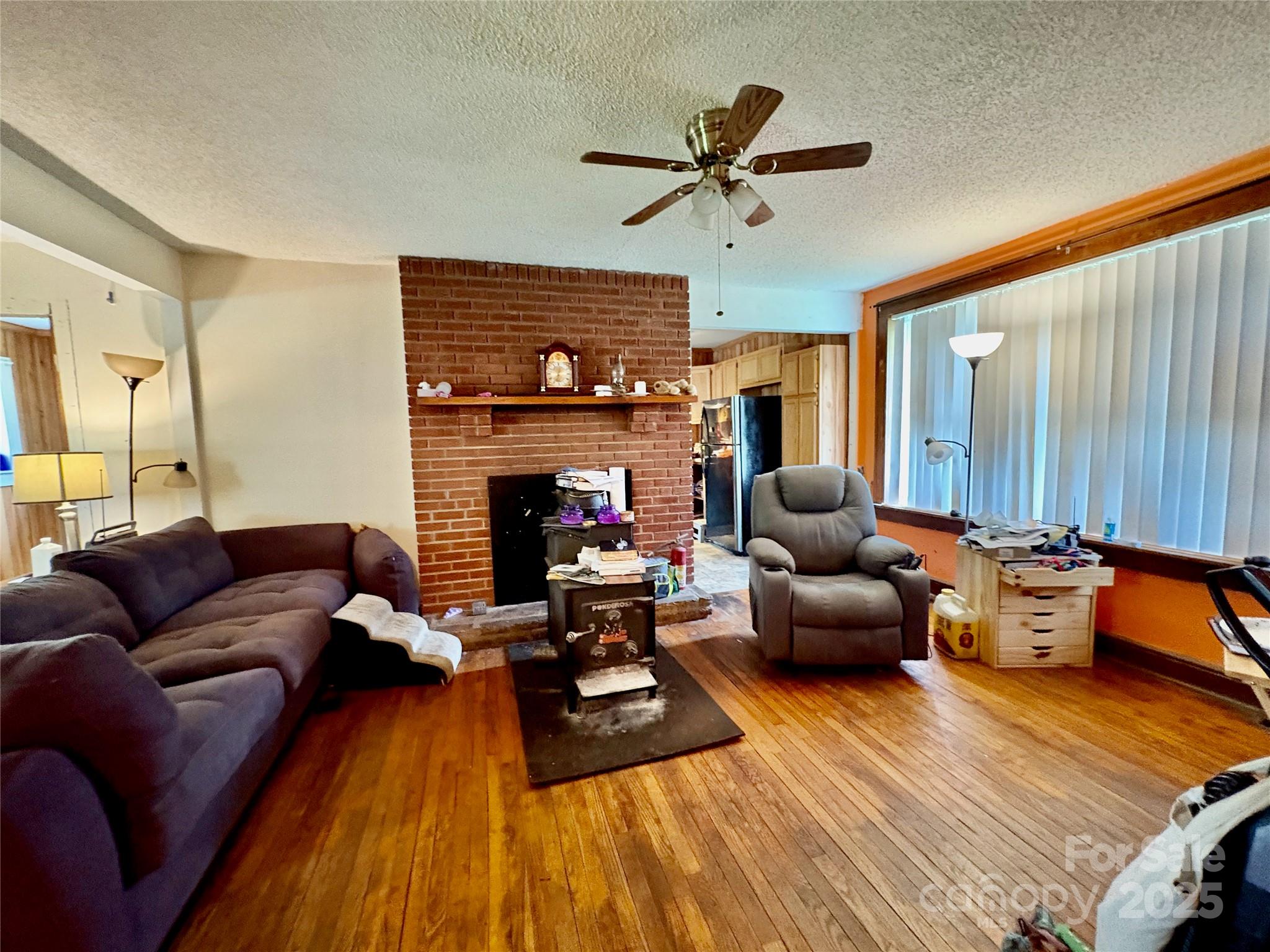 78 Moffitt Hill Church Road Old Fort, NC 28762 - Photo 23 of 37 a living room with furniture and a fireplace