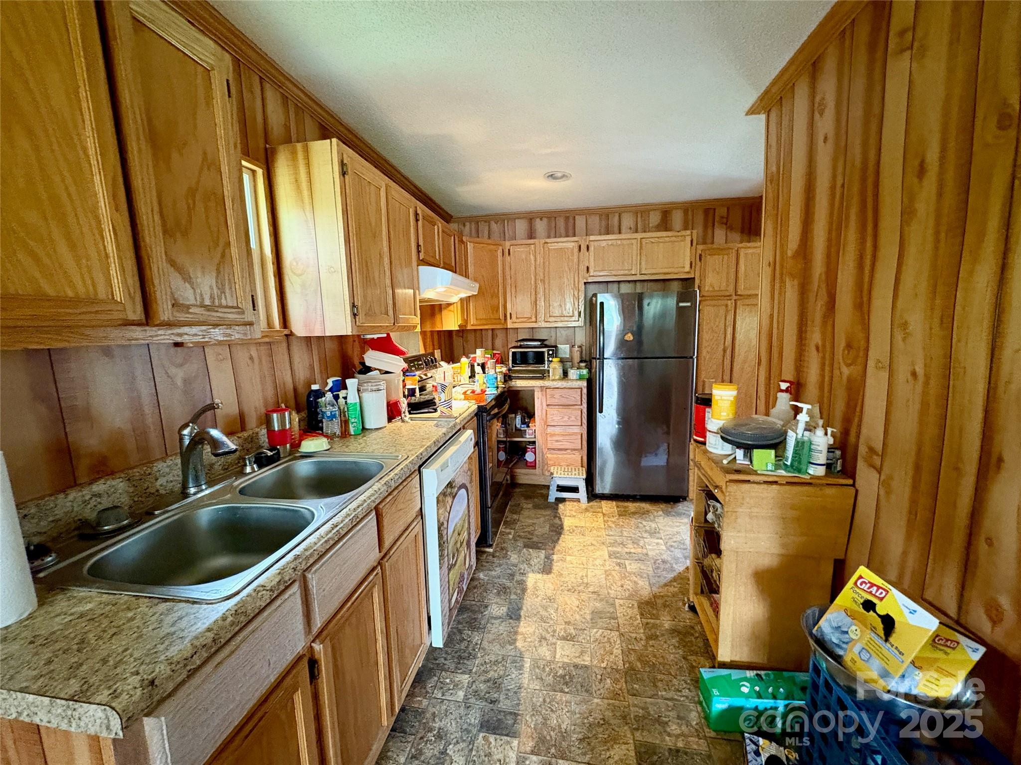 78 Moffitt Hill Church Road Old Fort, NC 28762 - Photo 26 of 37 a kitchen that has a sink stainless steel appliances a counter space and a window