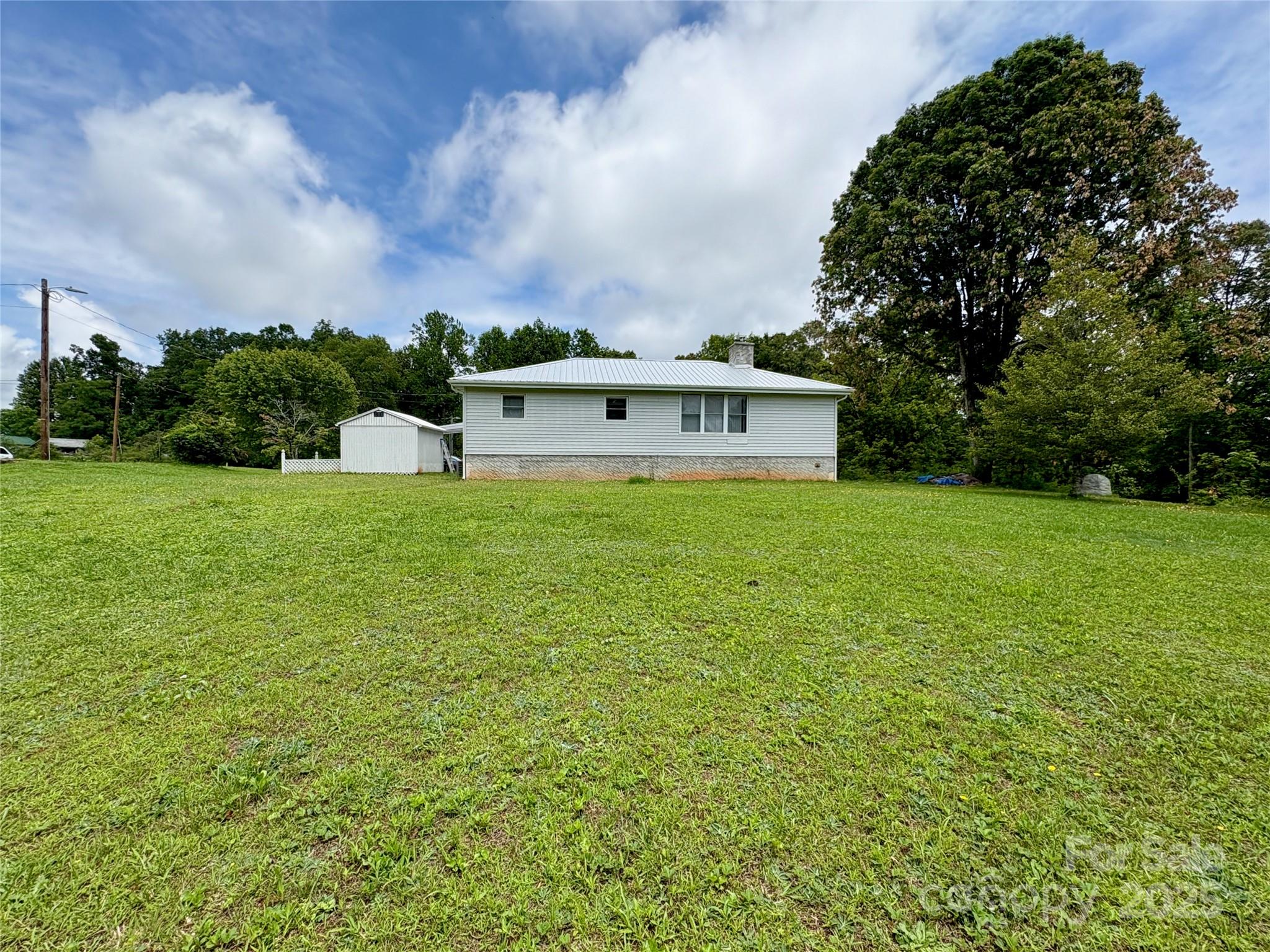 78 Moffitt Hill Church Road Old Fort, NC 28762 - Photo 3 of 37 a view of a house with a big yard and a large tree