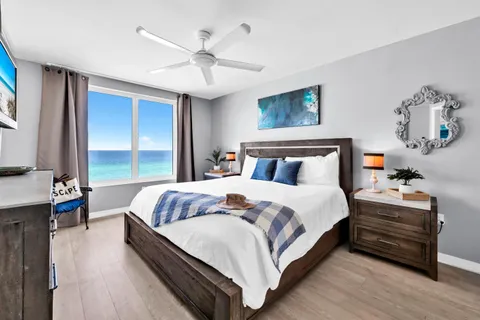 a bedroom with a large bed and a flat screen tv