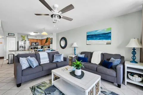 a living room with furniture kitchen view and a table