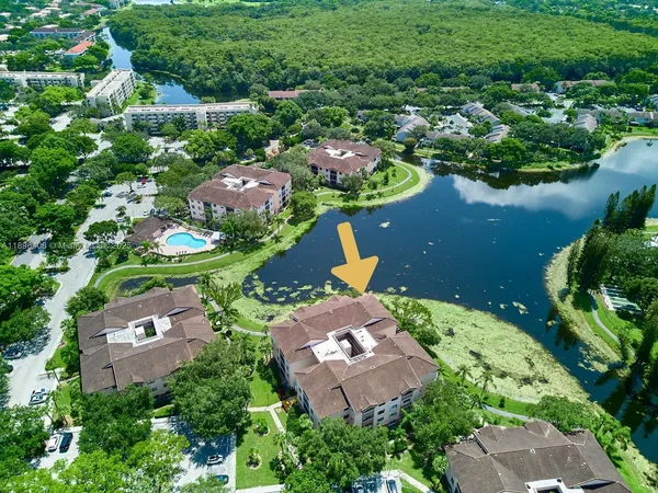 an aerial view of a house with a yard and lake view