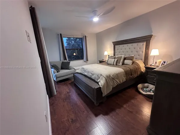 a bedroom with a bed and a wooden floor