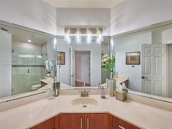 a bathroom with a glass shower door