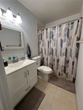 a large bedroom with a bed and a flat screen tv