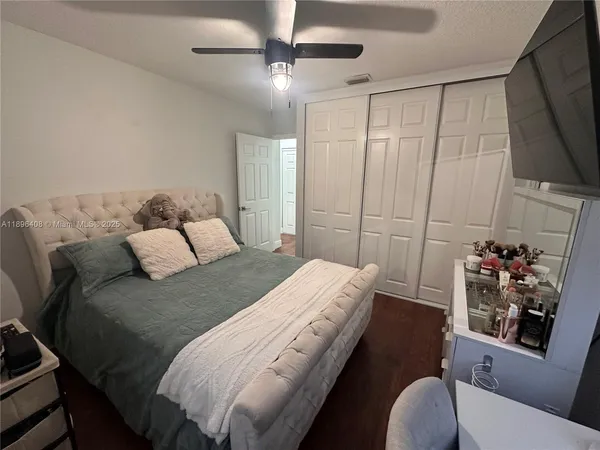 a bedroom with a bed couch and a window