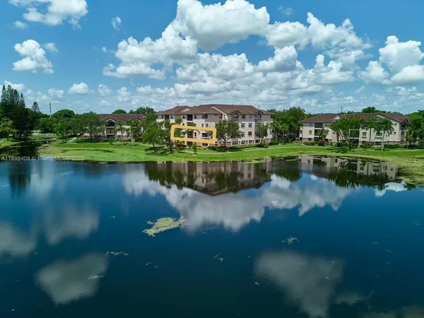 a view of a lake with houses in the background