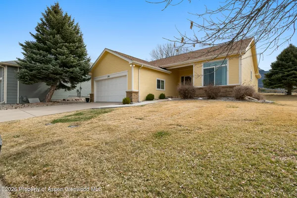 a view of a house with a yard covered with snow