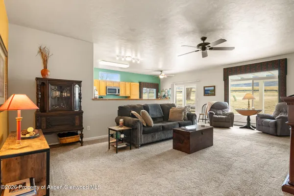 a living room with furniture gym equipment and a window