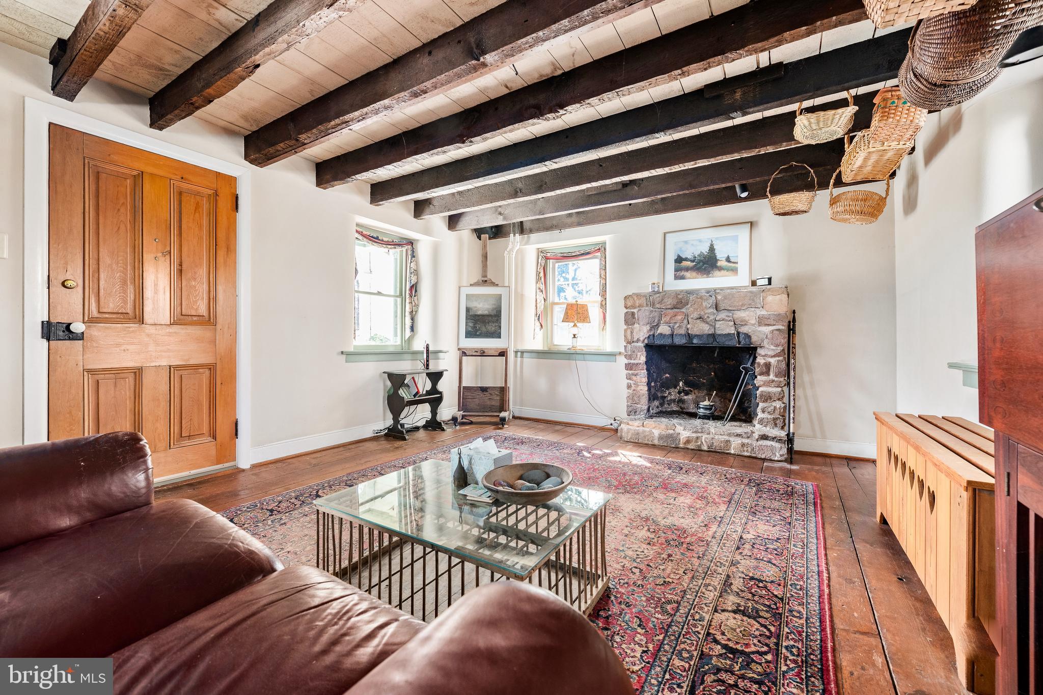 69 Kolb Road Spring City, PA 19475 - Photo 3 of 20 The living room w/ a fireplace & original beams