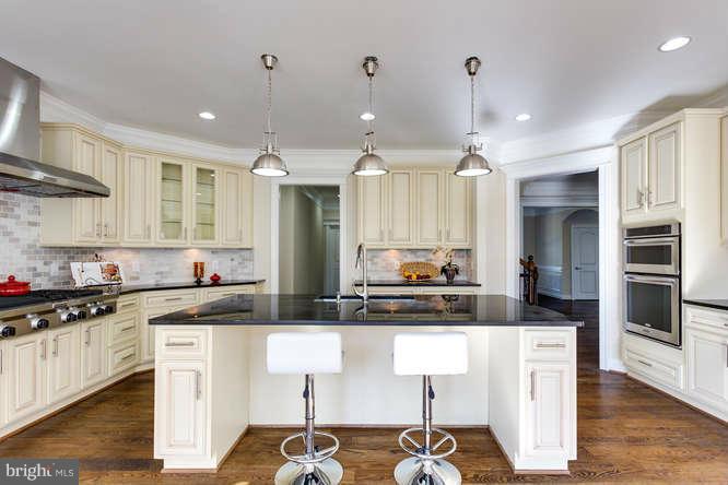 9423 Old Courthouse Road Vienna, VA 22182 - Photo 14 of 30 a kitchen with kitchen island granite countertop a sink cabinets and stainless steel appliances