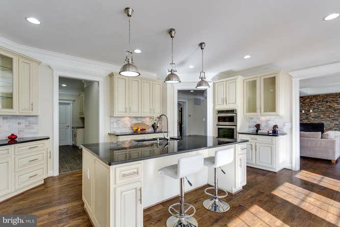 9423 Old Courthouse Road Vienna, VA 22182 - Photo 15 of 30 a kitchen with stainless steel appliances kitchen island granite countertop a sink and cabinets
