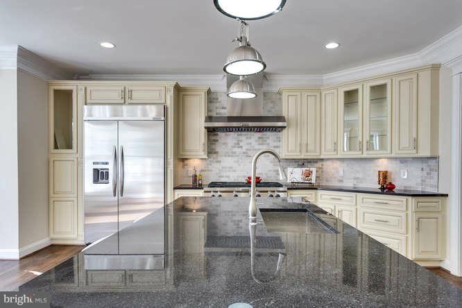 9423 Old Courthouse Road Vienna, VA 22182 - Photo 16 of 30 a kitchen with stainless steel appliances granite countertop a sink a stove and a refrigerator