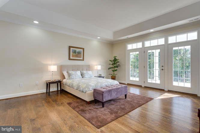 9423 Old Courthouse Road Vienna, VA 22182 - Photo 21 of 30 a spacious bedroom with a bed and wooden floor