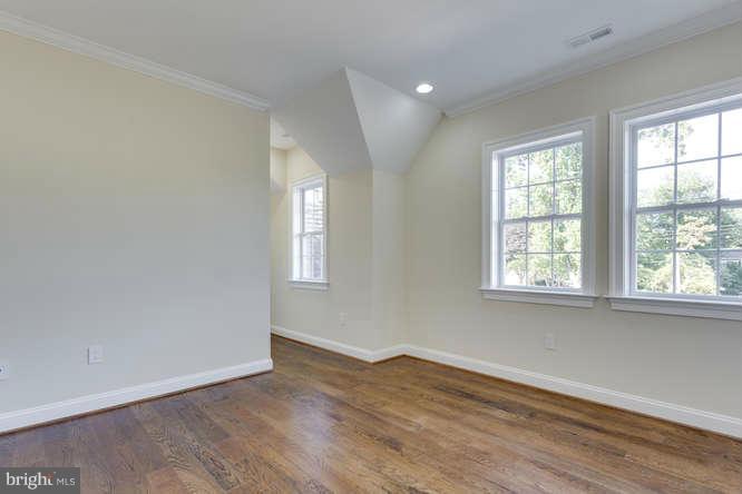 9423 Old Courthouse Road Vienna, VA 22182 - Photo 23 of 30 an empty room with wooden floor and windows