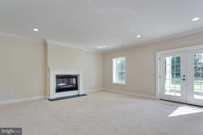 9423 Old Courthouse Road Vienna, VA 22182 - Photo 25 of 30 an empty room with windows fireplace and a sink