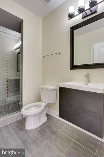 9423 Old Courthouse Road Vienna, VA 22182 - Photo 28 of 30 a bathroom with a toilet a sink and a mirror