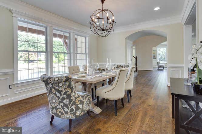 9423 Old Courthouse Road Vienna, VA 22182 - Photo 9 of 30 a dining room with wooden floor a chandelier a wooden table and chairs