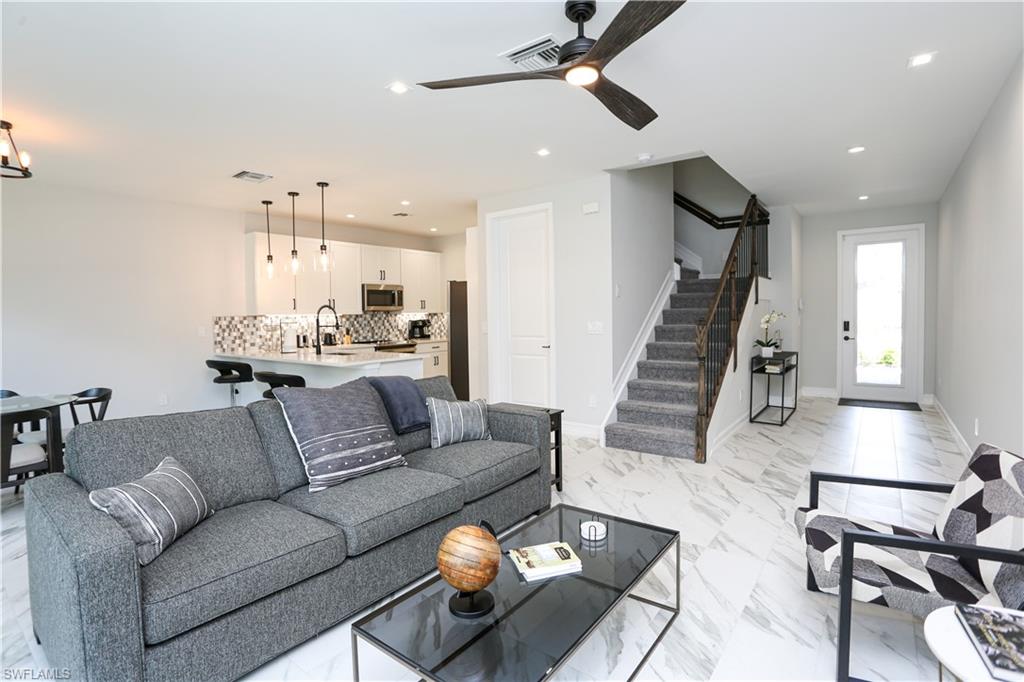 7654 Rockefeller Drive Naples, FL 34119 - Photo 15 of 35 a living room with furniture and wooden floor