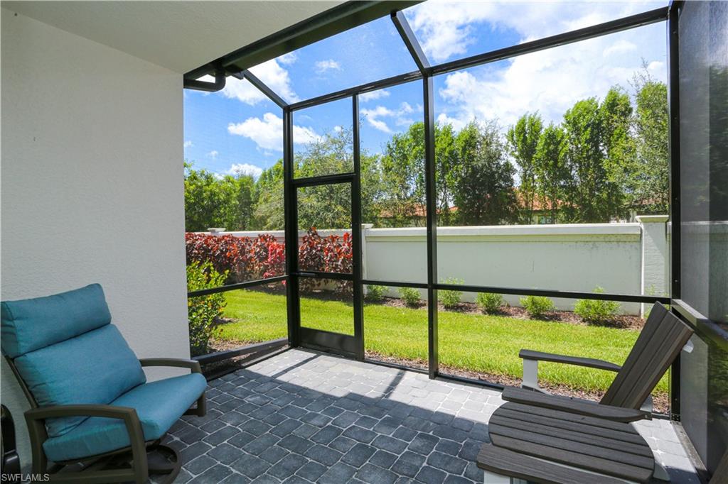 7654 Rockefeller Drive Naples, FL 34119 - Photo 2 of 35 a view of a chairs and table in the patio