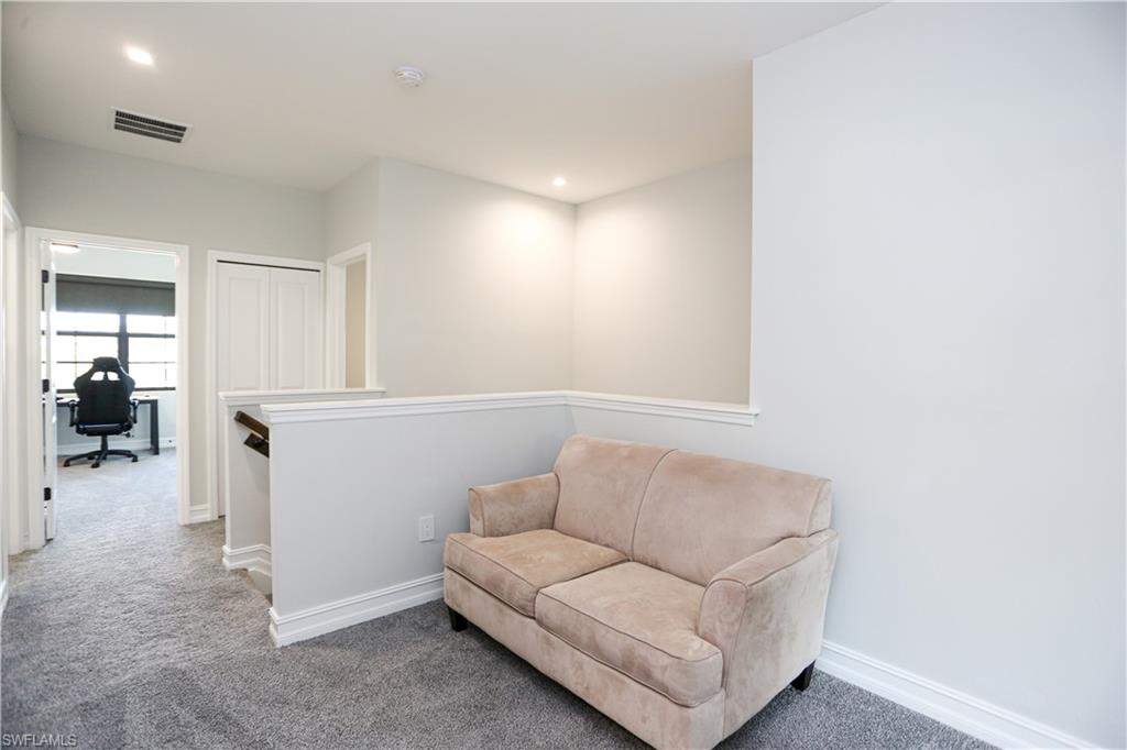 7654 Rockefeller Drive Naples, FL 34119 - Photo 21 of 35 a living room with furniture and a window