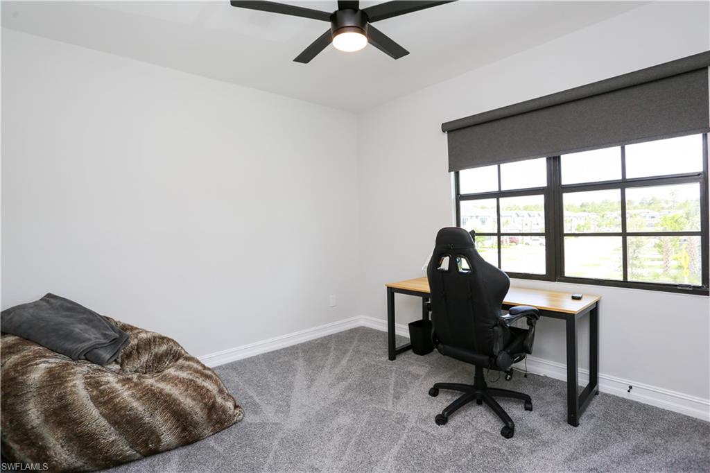 7654 Rockefeller Drive Naples, FL 34119 - Photo 24 of 35 a view of a workspace with furniture and a window