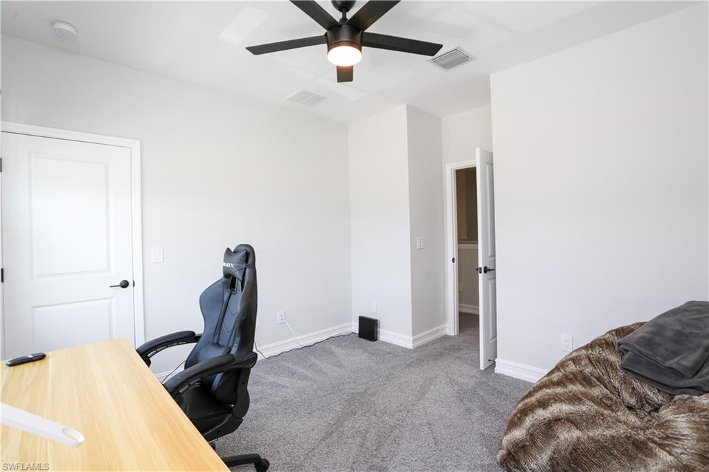 7654 Rockefeller Drive Naples, FL 34119 - Photo 25 of 35 a view of a livingroom with furniture and a ceiling fan