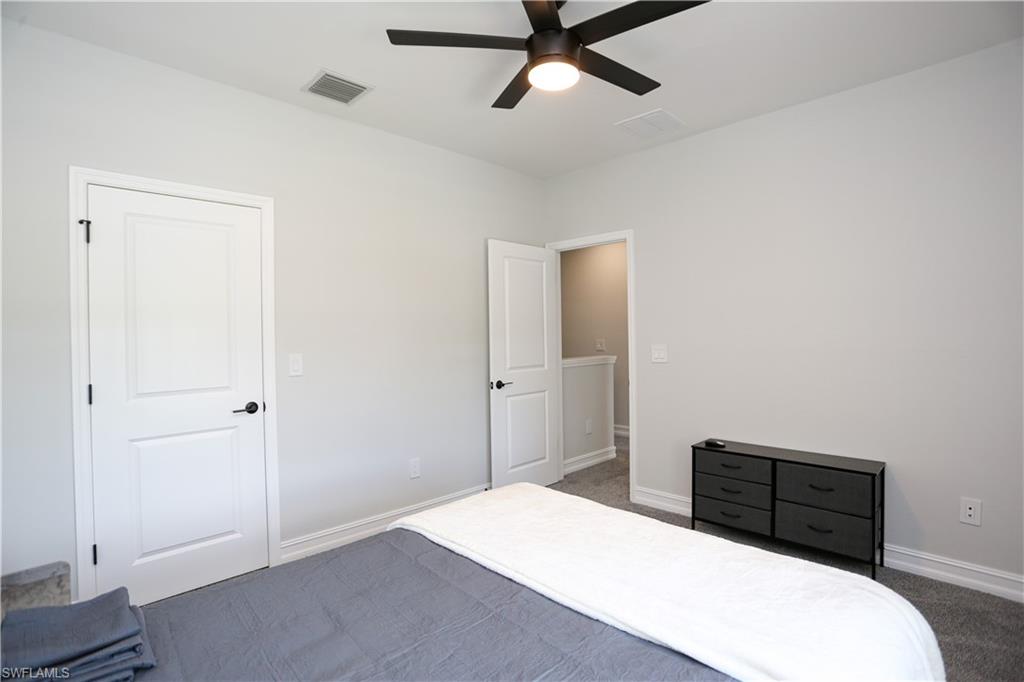 7654 Rockefeller Drive Naples, FL 34119 - Photo 28 of 35 a bedroom with a bed and a closet