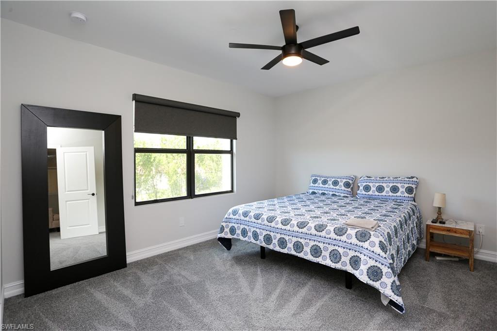 7654 Rockefeller Drive Naples, FL 34119 - Photo 29 of 35 a bedroom with a bed and a window