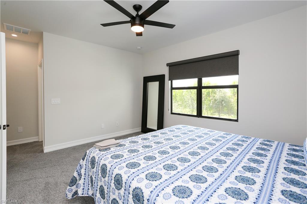 7654 Rockefeller Drive Naples, FL 34119 - Photo 32 of 35 a bedroom with a large bed and a window