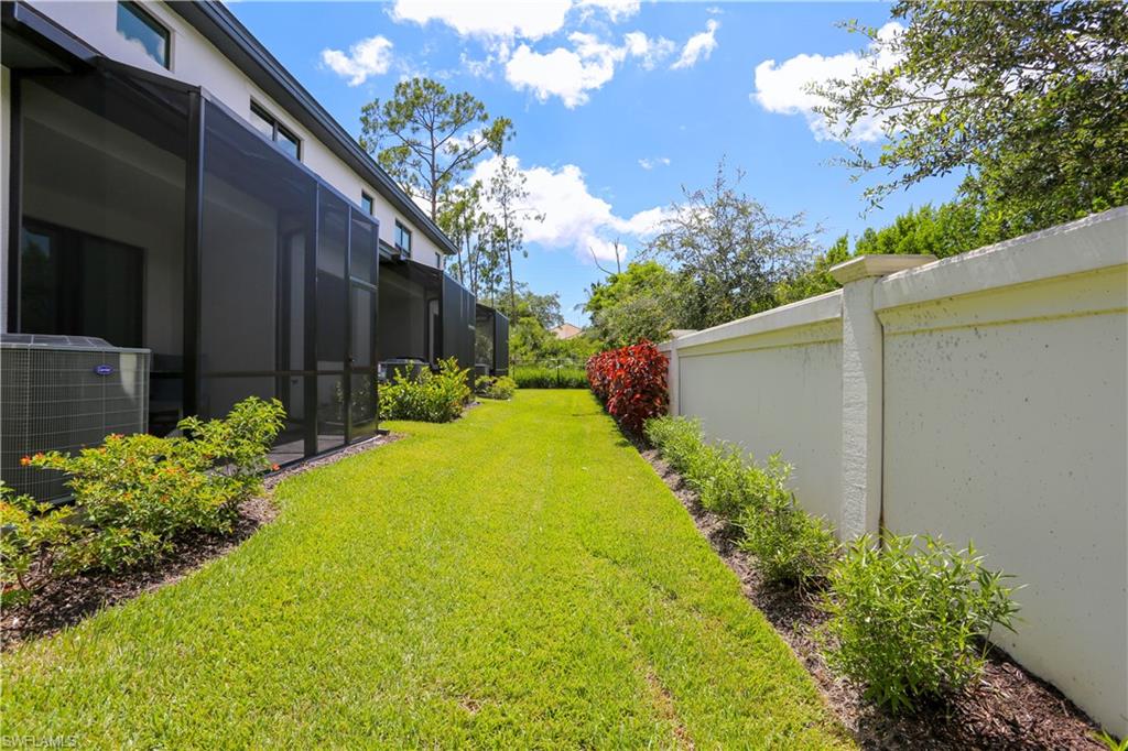 7654 Rockefeller Drive Naples, FL 34119 - Photo 4 of 35 a view of a backyard with plants