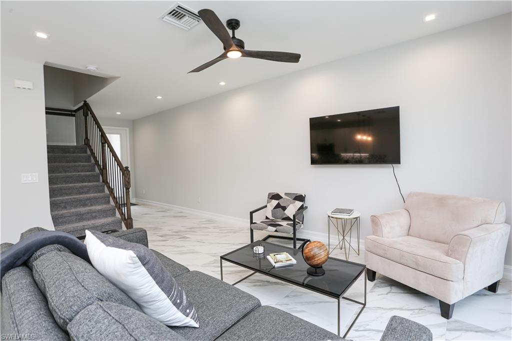 7654 Rockefeller Drive Naples, FL 34119 - Photo 9 of 35 a living room with furniture and a flat screen tv