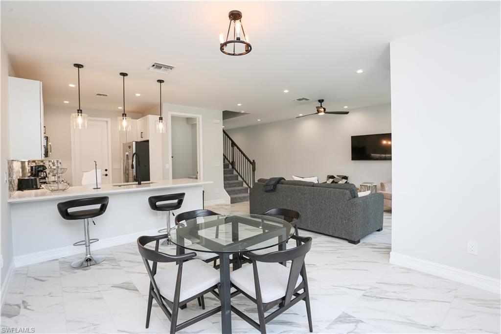7654 Rockefeller Drive Naples, FL 34119 - Photo 10 of 35 a view of a dining room with furniture