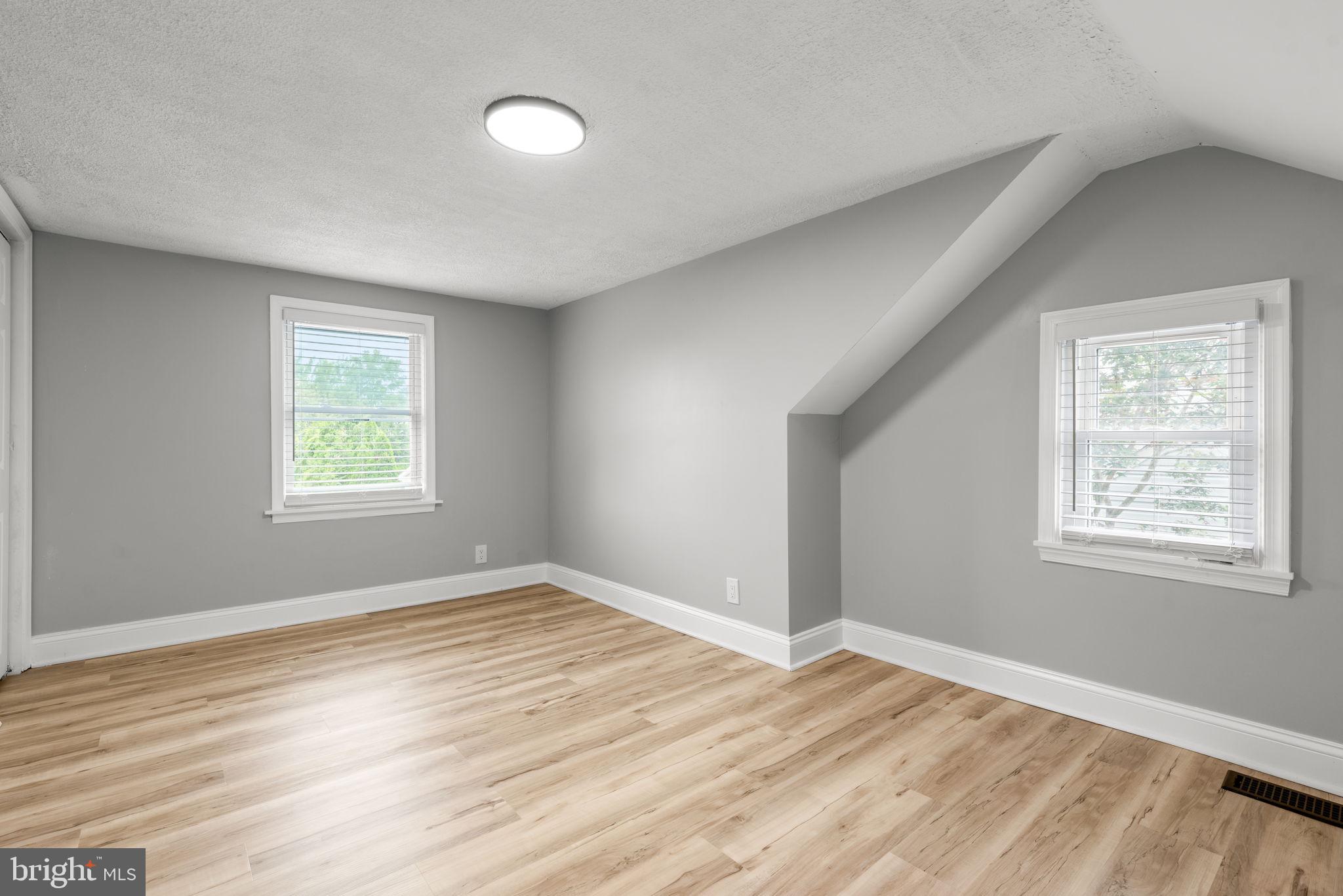 3406 Louth Road Dundalk, MD 21222 - Photo 17 of 30 a view of an empty room with wooden floor and a window